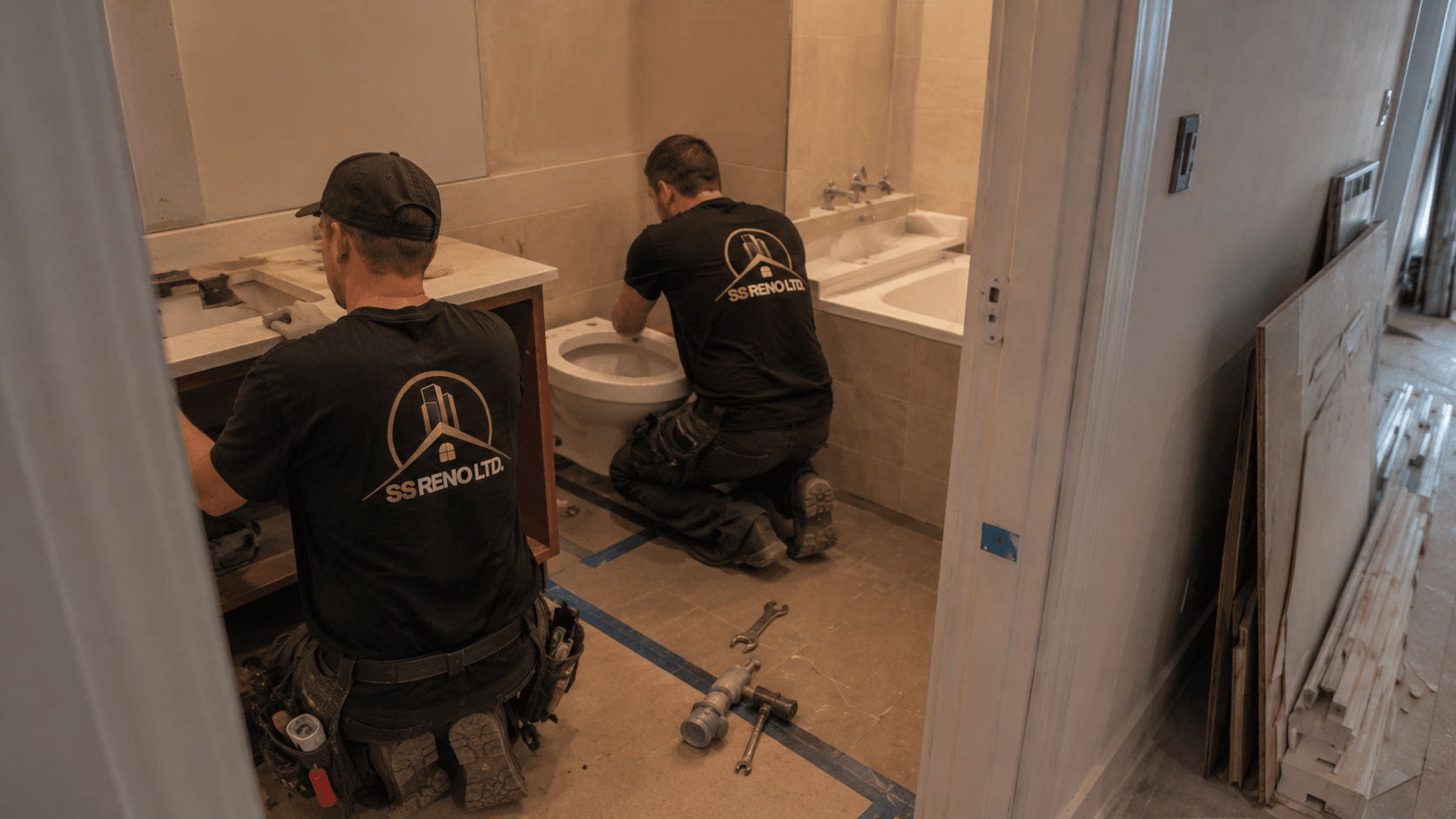 SS RENO LTD. team completing bathroom fixture and vanity installation work
