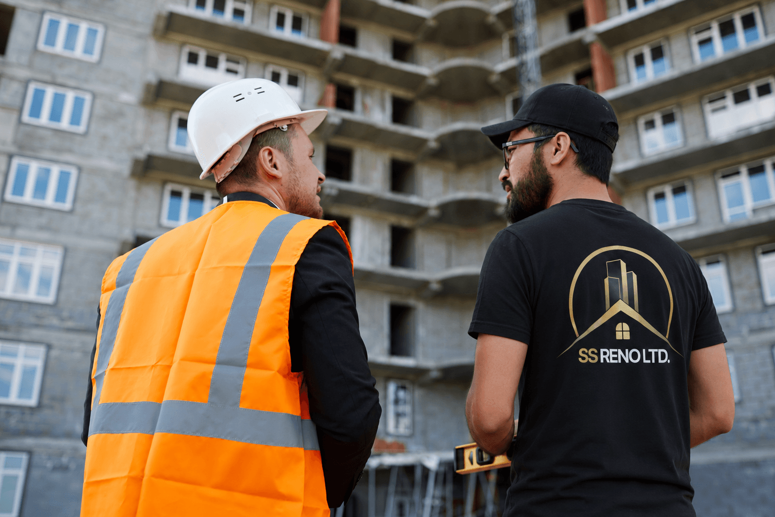 SS RENO LTD. team member coordinating renovation work on site with a construction professional