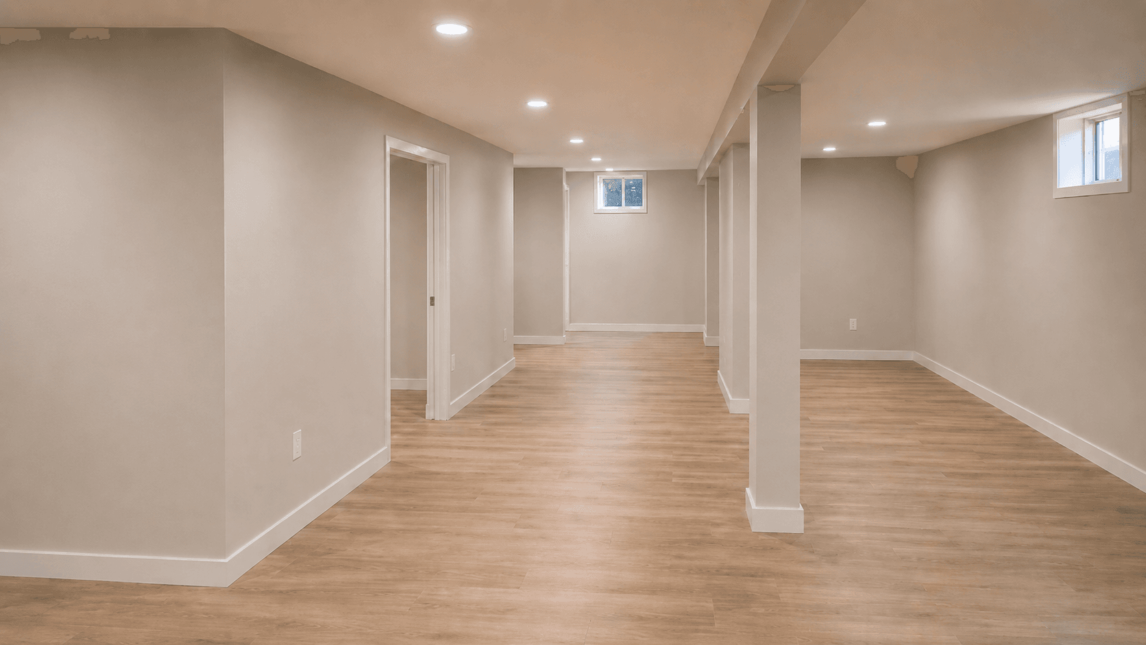 Finished basement after renovation with bright walls, recessed lighting, clean flooring, and open living space