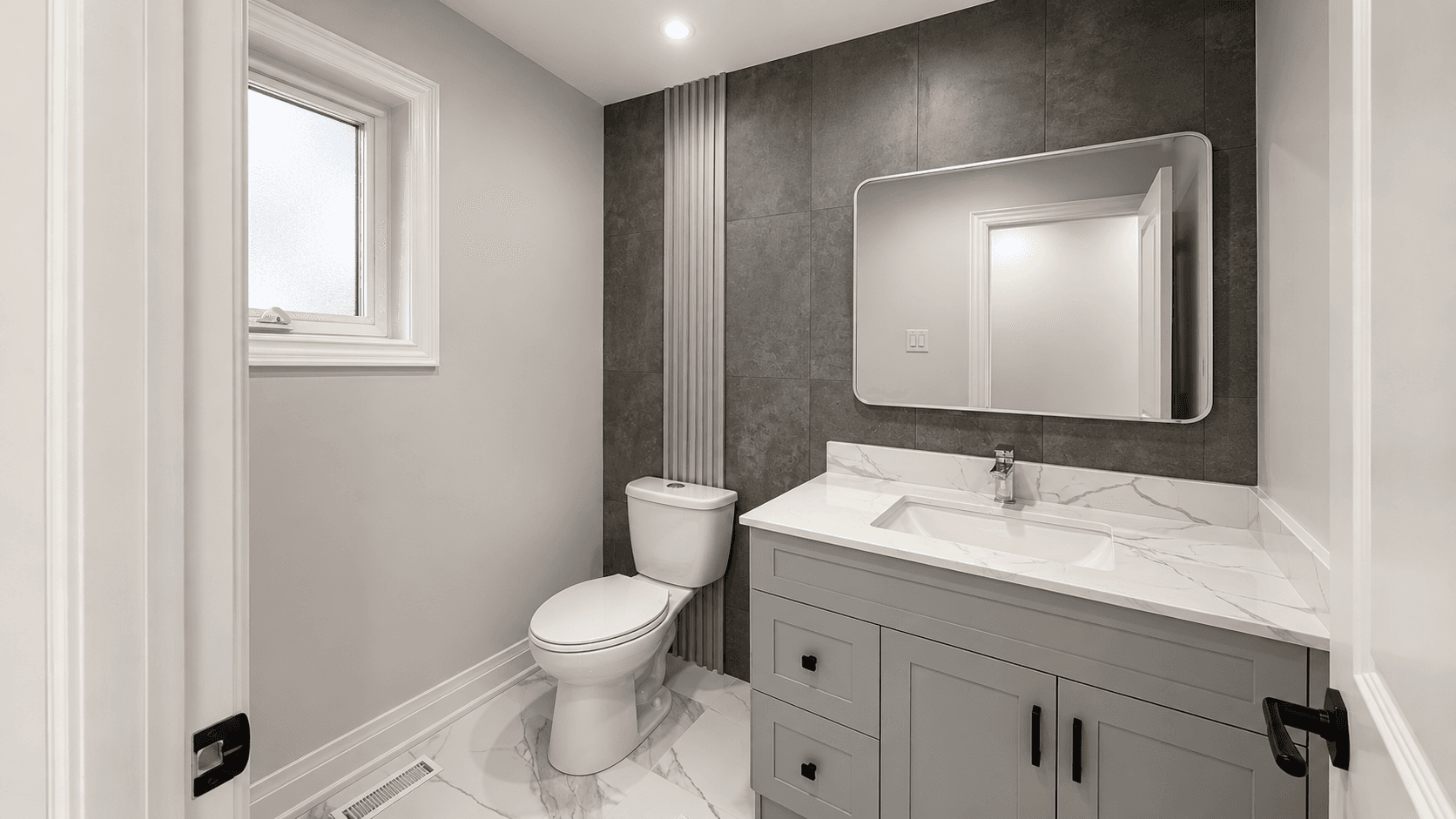 Finished bathroom after renovation with glass shower, vanity, mirror lighting, and clean tile work